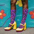 Coquette-style crew socks featuring a bold black background with hot pink and purple psychedelic squiggles, cherries, and shiny pink bows. Made of a soft polyester-spandex blend with reinforced black toe and heel. Fits US women's sizes 5–12 and men's up to 12. Stretchy, colorful, and cute for dopamine dressing.